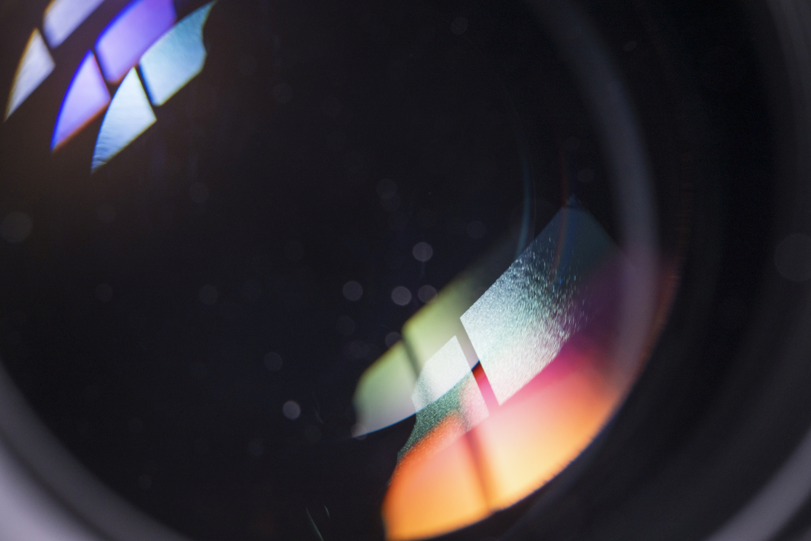 Detailed close-up of a camera lens with light reflections and optical elements.